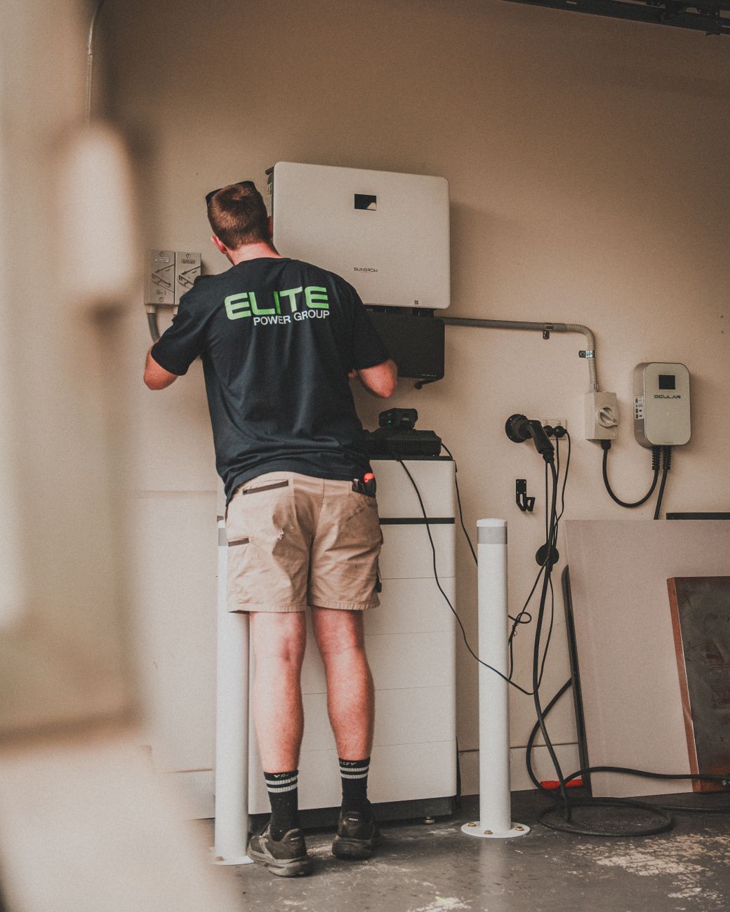 Technician installs a residential energy storage system on the wall